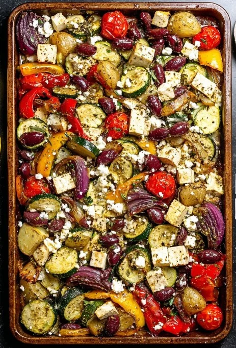 High-protein vegan Greek sheet pan dish with colorful vegetables and herbs