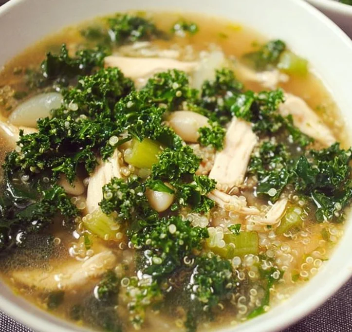 Slow cooker quinoa chicken soup with kale in a bowl